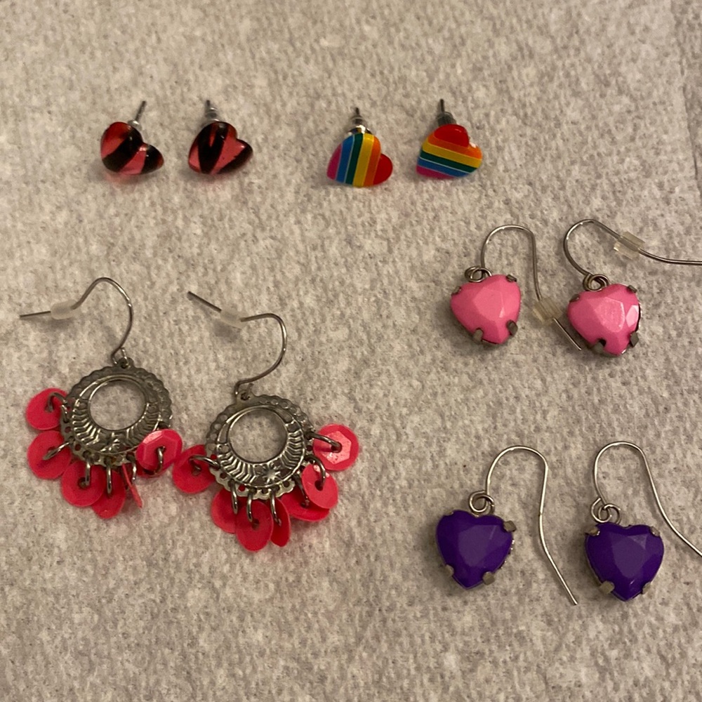 5 pairs of earrings: 3 dangling and 2 post. 4 of the pairs are heart-shaped